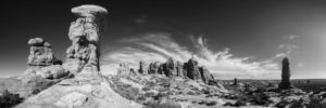 Million Year Gambit. Black and white panoramic photograph of weathered and eroded sandstone sculptures protruding from the desert floor of Arches National Park outside Moab Utah appearing as an age old game of chess Black and white panoramic photograph of weathered and eroded sandstone sculptures standing on the desert floor of Arches National Park outside Moab Utah appearing as an age old game of chess