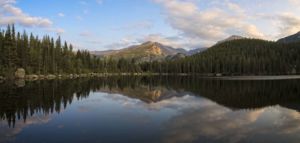 Reflecting On Longs. Early summer evening sunset over Longs Peak with mirror reflection in Bear Lake of Rocky Mountain National Park Colorado. Early summer evening sunset over Longs Peak with mirror reflection in Bear Lake of Rocky Mountain National Park Colorado