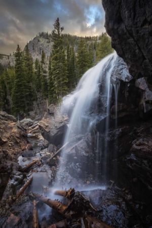 Voice Of The Mountain. Silky water long exposure landscape photograph of Hessie Falls waterfall during a fall sunset in the Indian Peaks Wilderness Boulder County Colorado Silky water long exposure landscape photograph of Hessie Falls waterfall during a fall sunset in the Indian Peaks Wilderness Boulder County Colorado